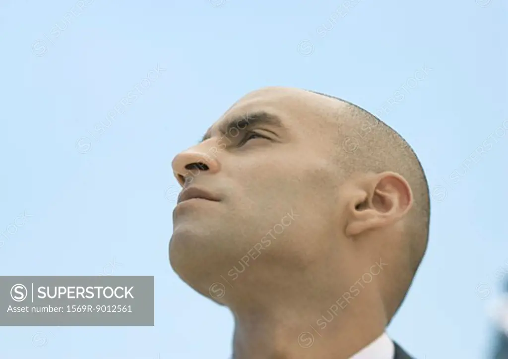 Man with shaved head, low angle view