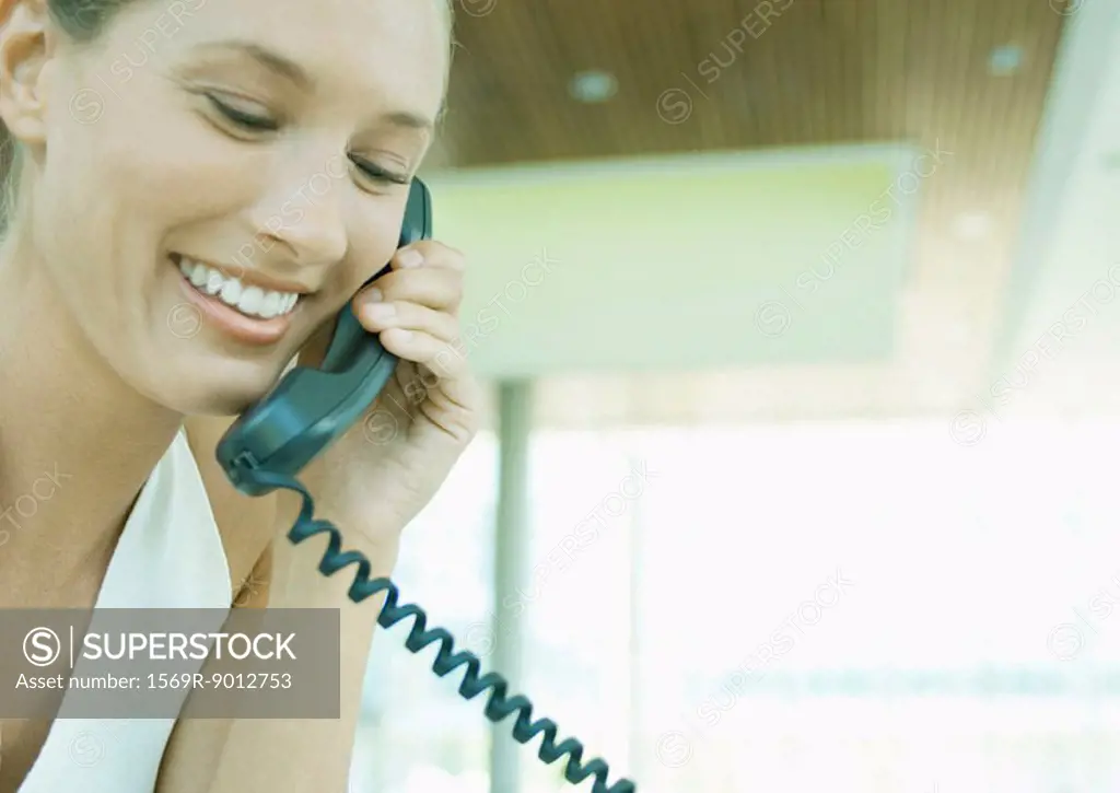 Woman using landline phone