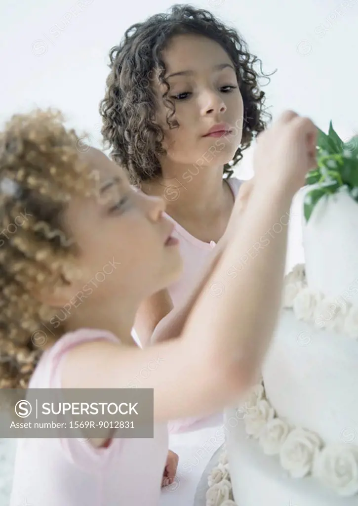 Girls looking at wedding cake