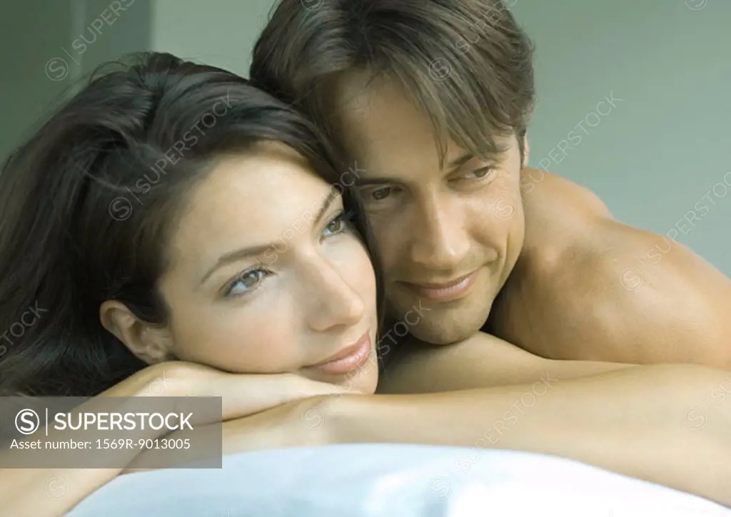 Couple lying in bed together