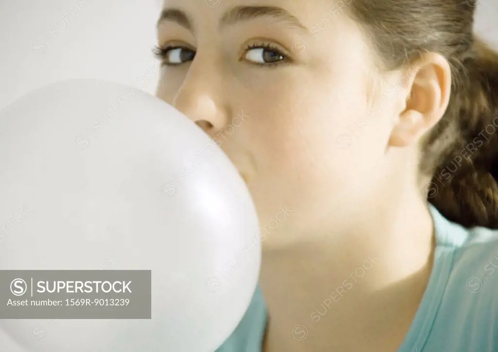 Teenage girl blowing bubble