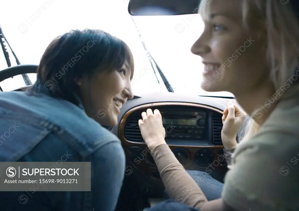 Two young adult female friends in car together