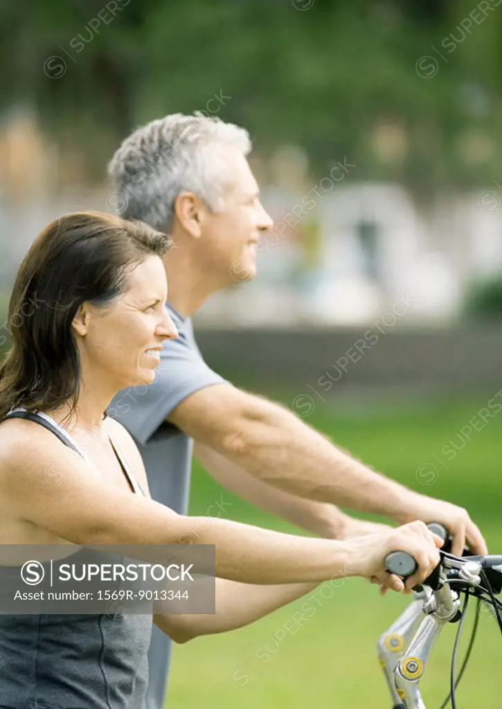 Mature couple on bikes, cropped