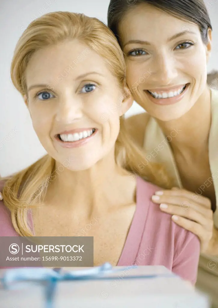 Two women smiling with gift