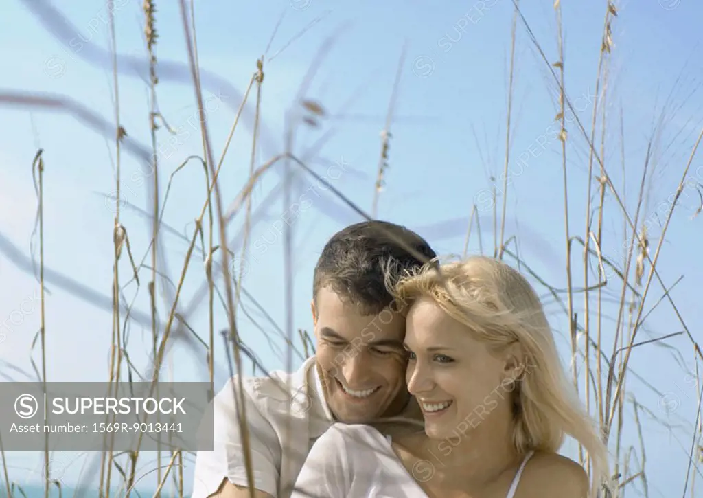 Couple embracing in dune grass