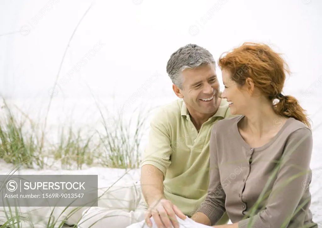 Mature couple sitting on beach