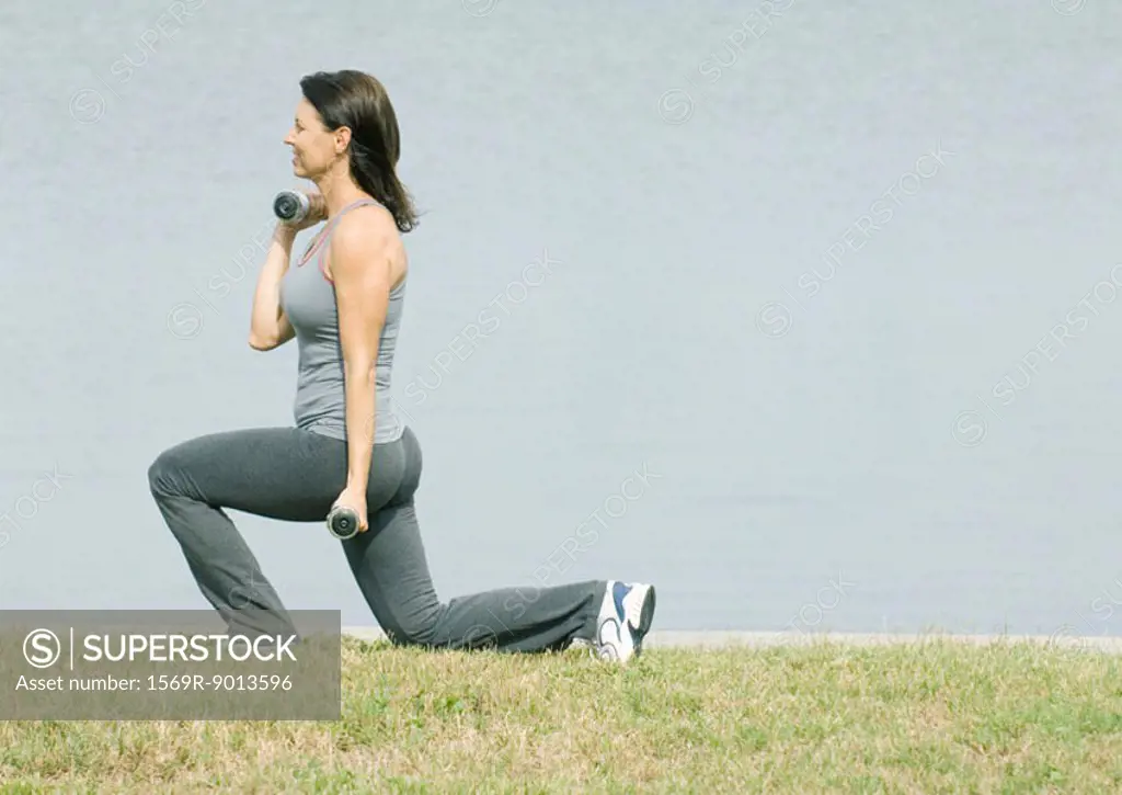 Woman working out by edge of water