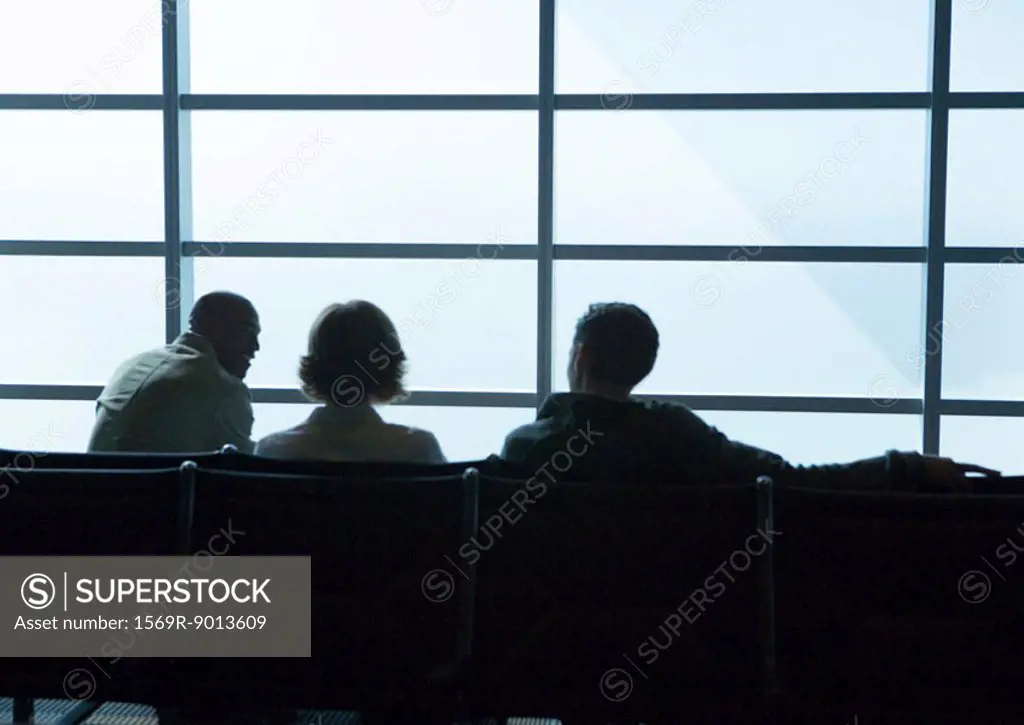 Silhouette of travelers in airport lounge