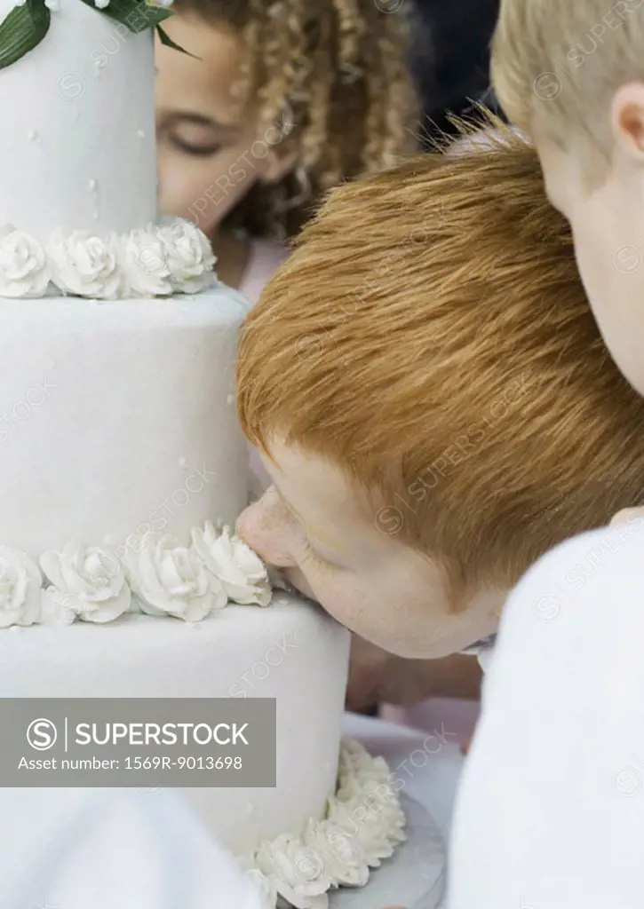 Boy eating wedding cake