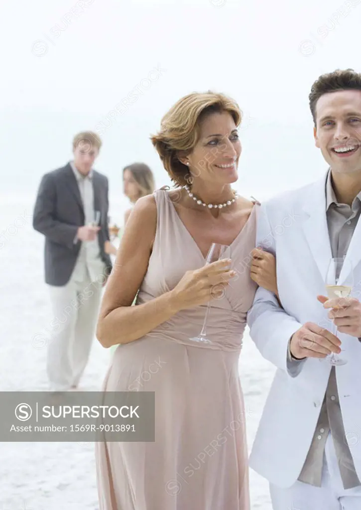 People dressed in formal clothing on beach