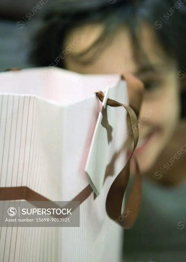 Shopping bag and woman´s face in background