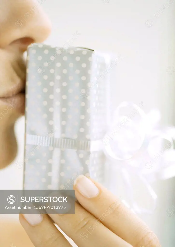 Woman kissing gift, close-up