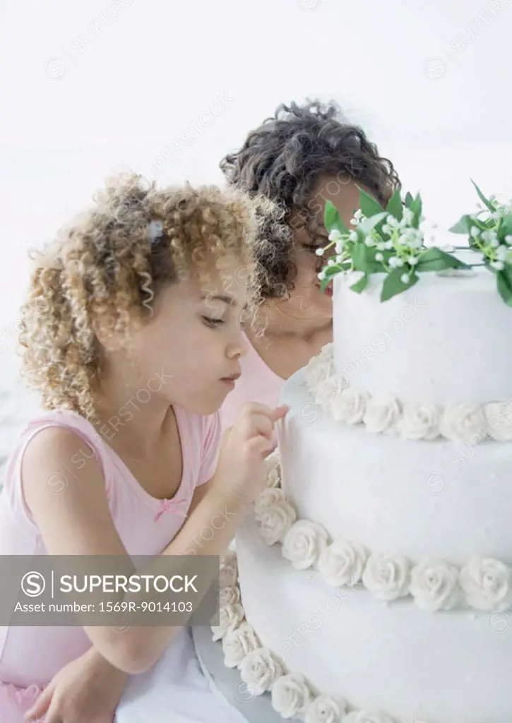 Girls looking at wedding cake
