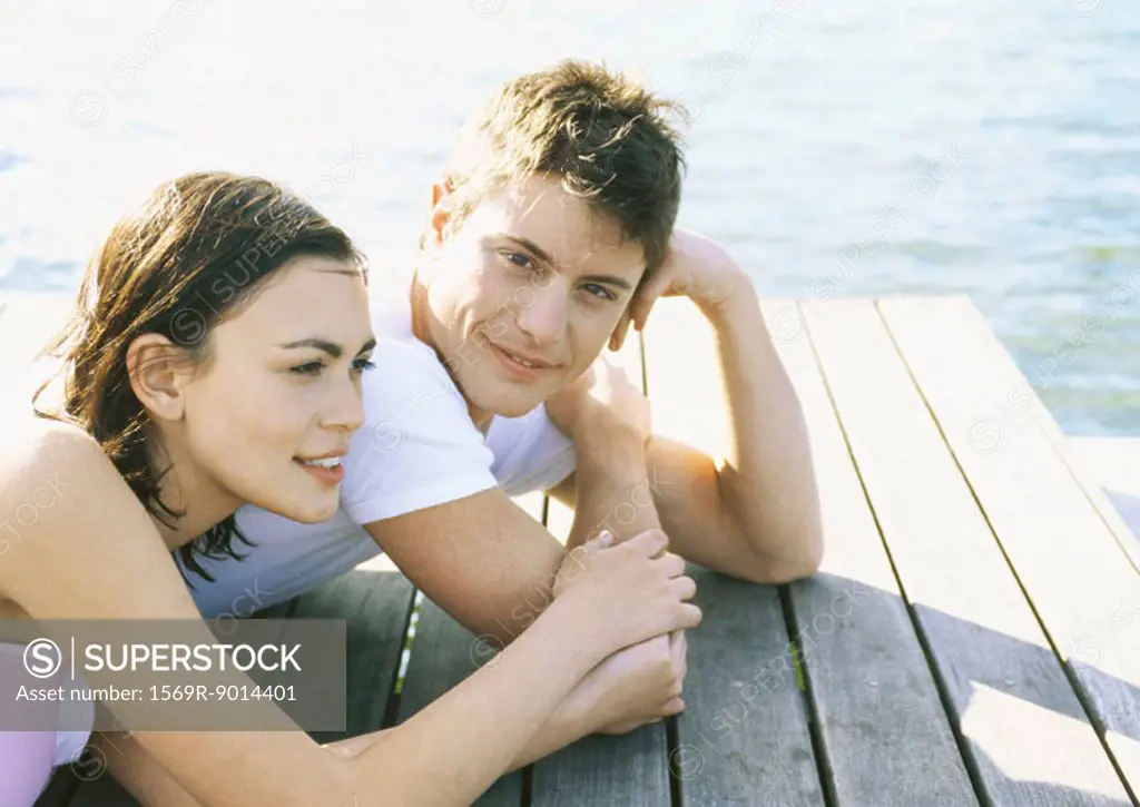 Young couple lying on dock