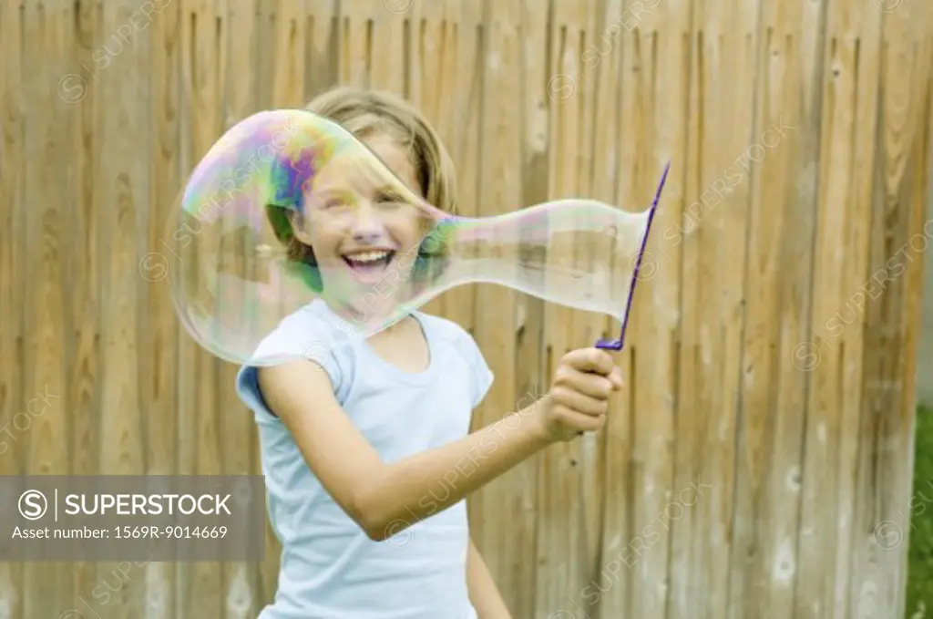 Girl making bubble with bubble wand