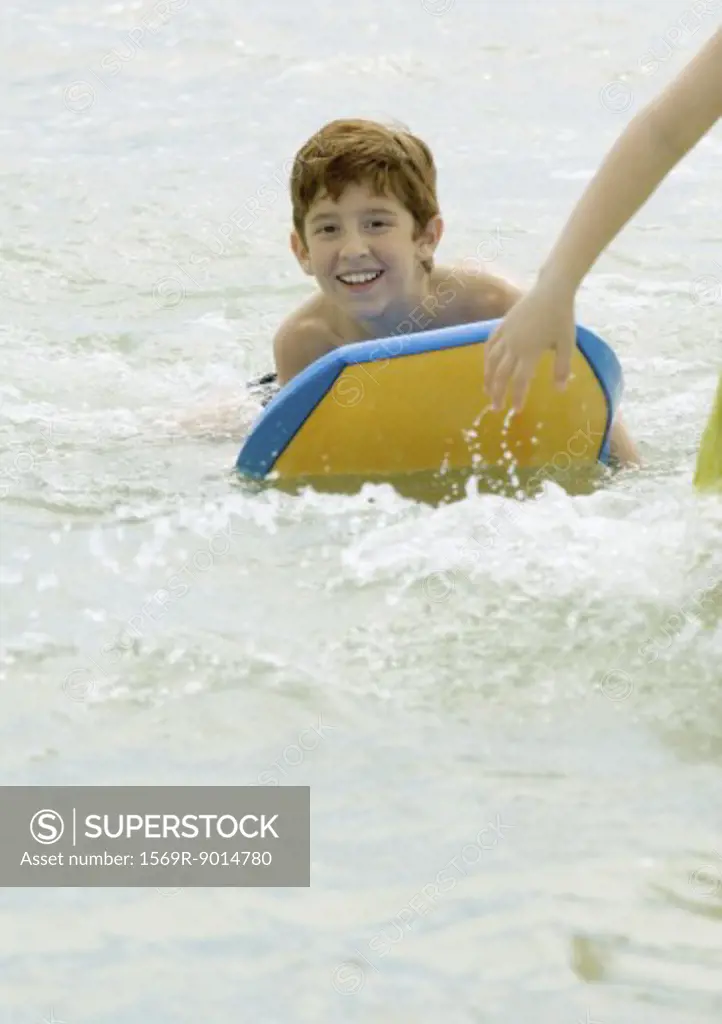 Boy on body board in sea
