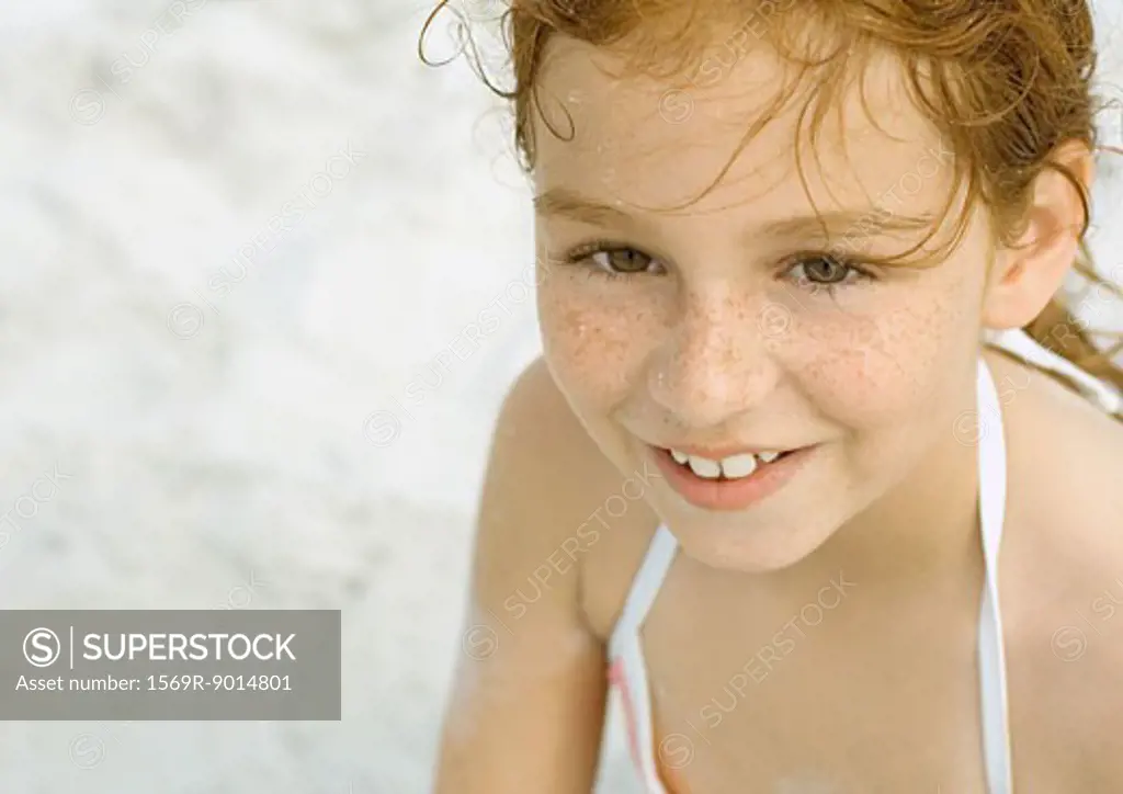 Girl smiling on beach, portrait