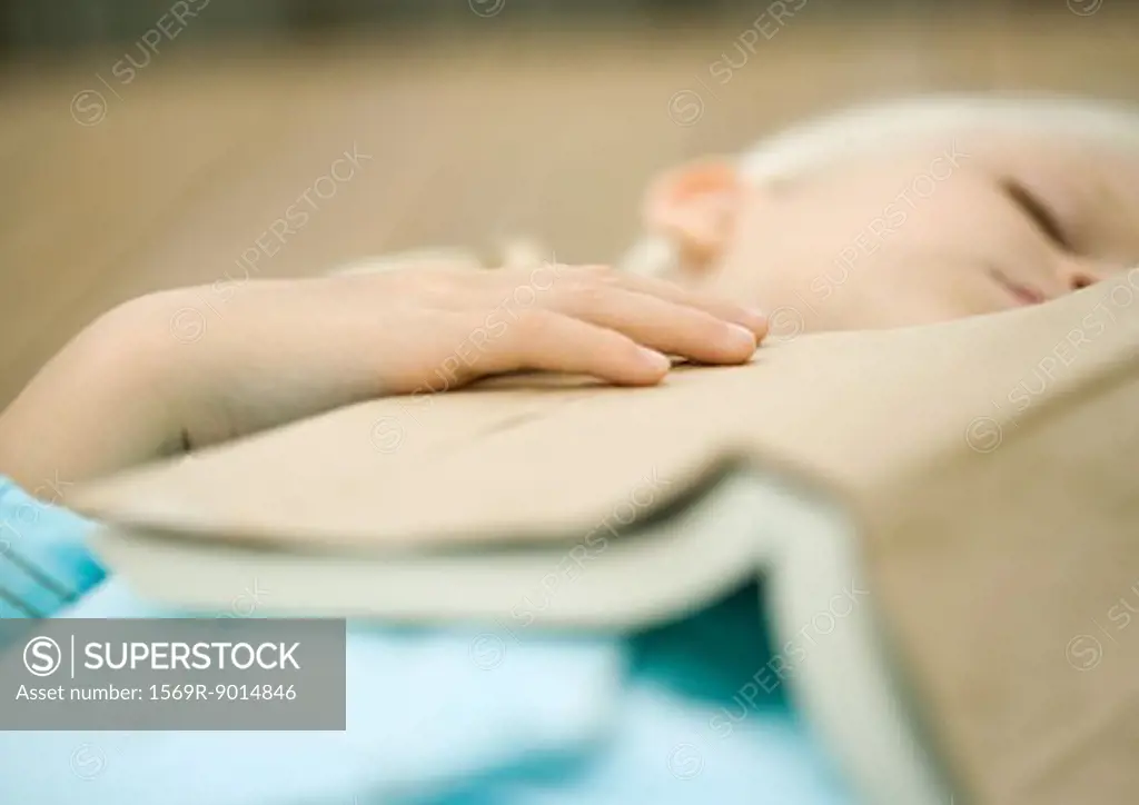 Girl sleeping with book on chest