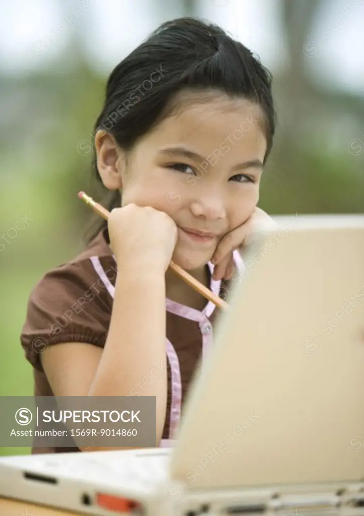 Girl using laptop, smiling