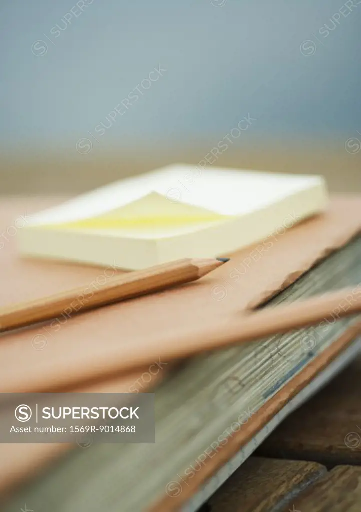Pencils and adhesive notes on school book