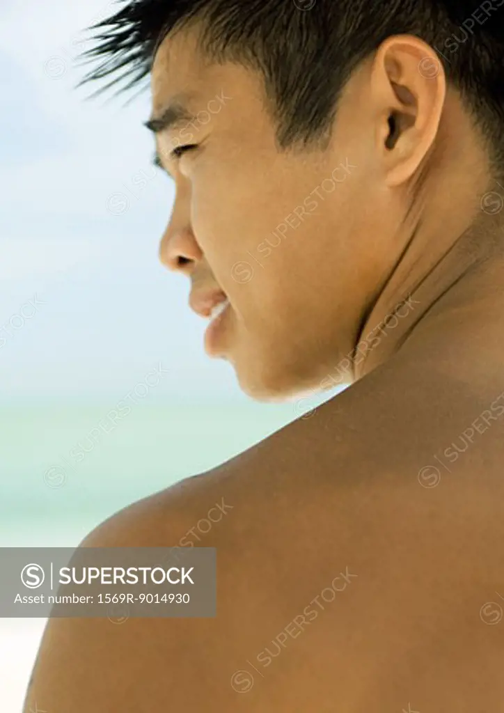 Young man, profile, sea in background