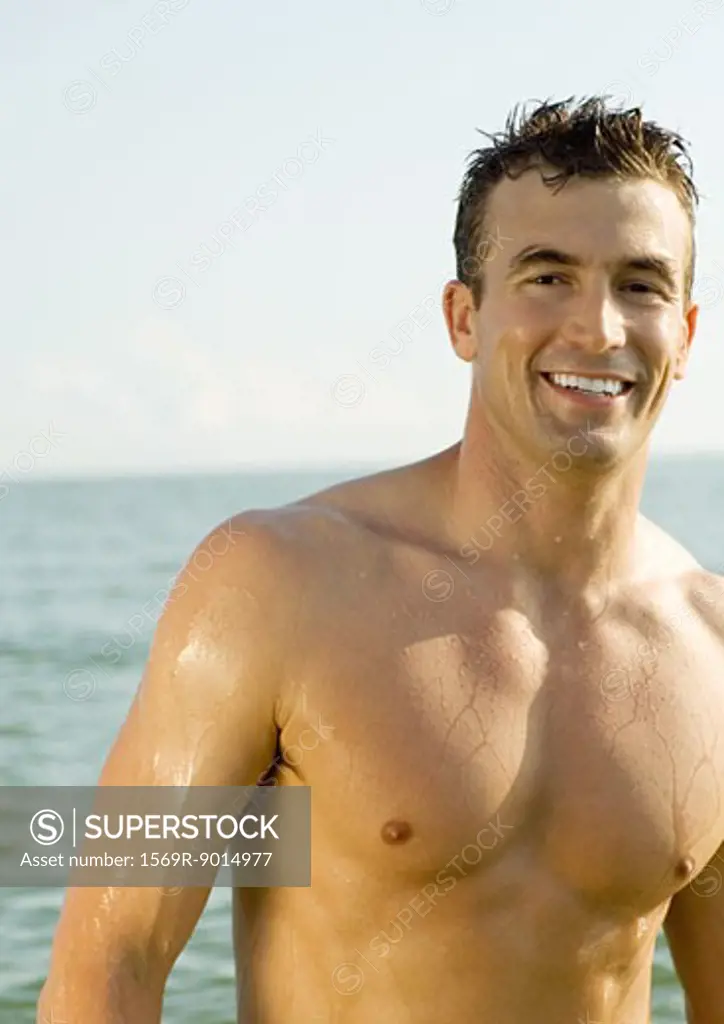 Barechested man smiling in sun