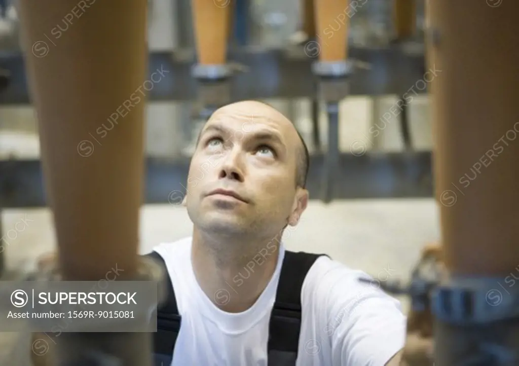 Factory worker, looking up