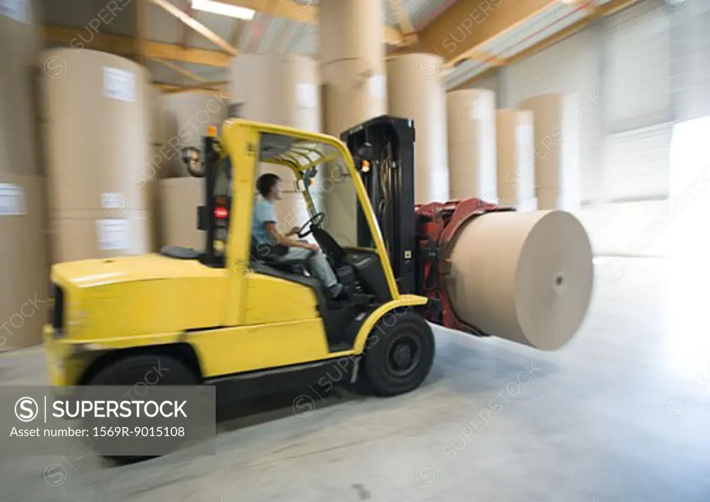 Fork lift carrying roll of paper