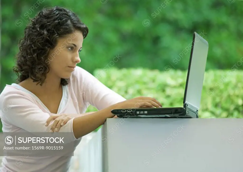 Woman using laptop outdoors