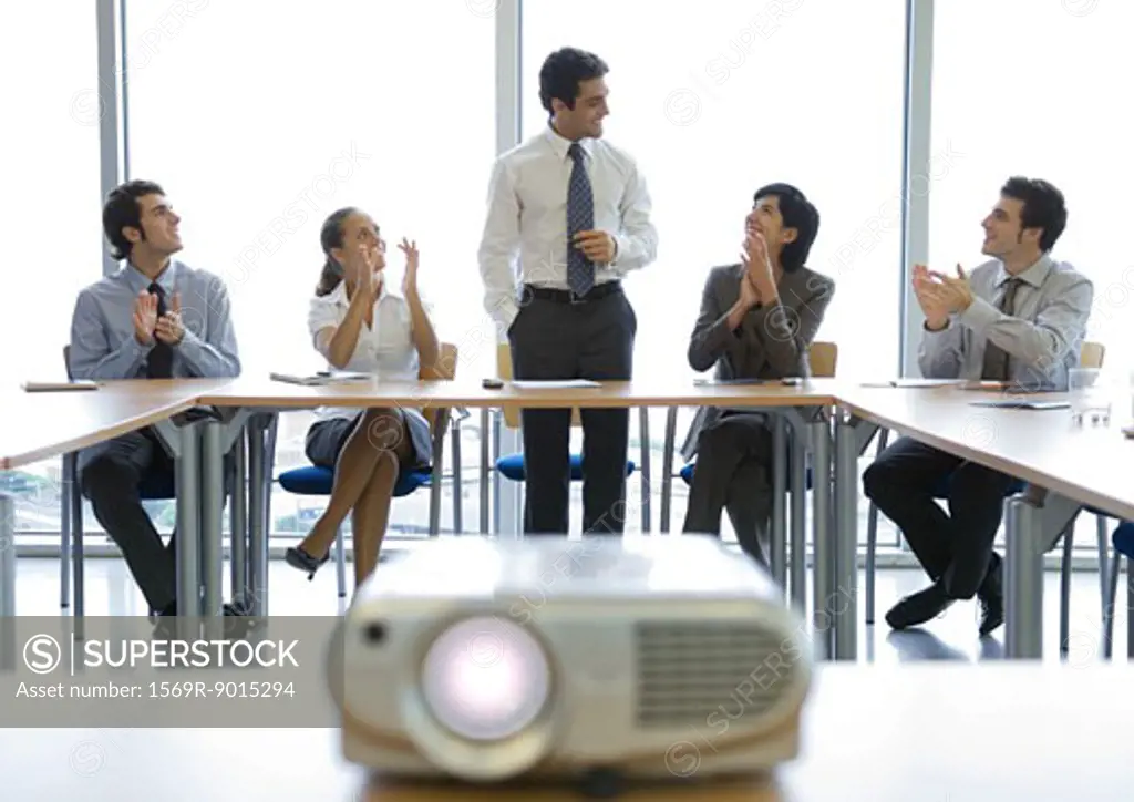 Business colleagues having meeting, videoprojector in foreground