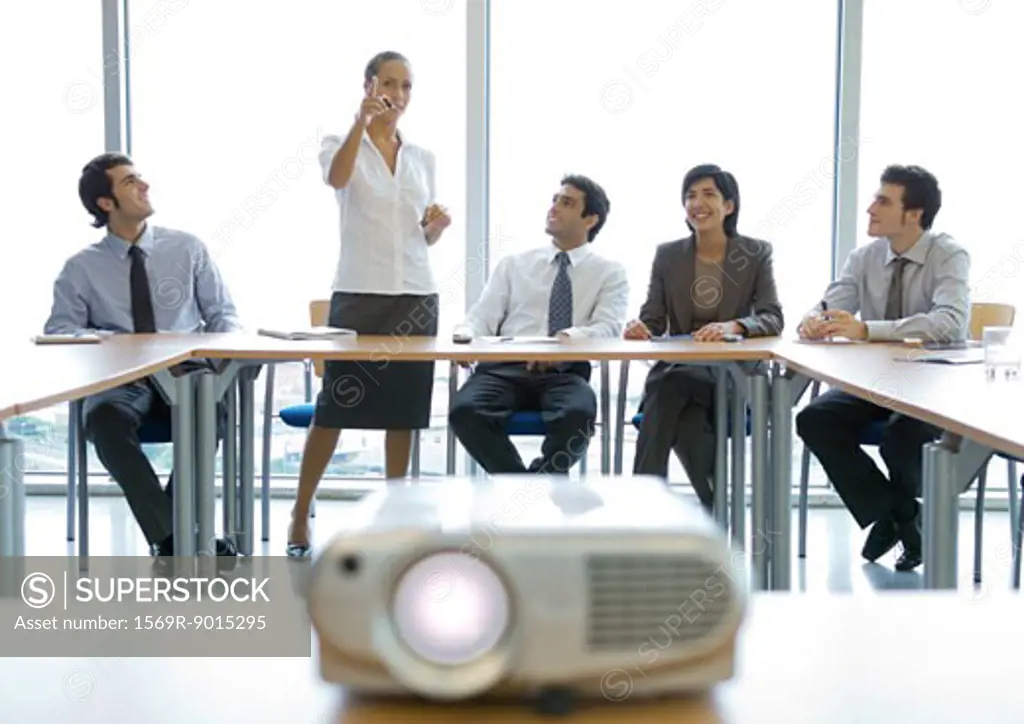 Business colleagues having meeting, videoprojector in foreground
