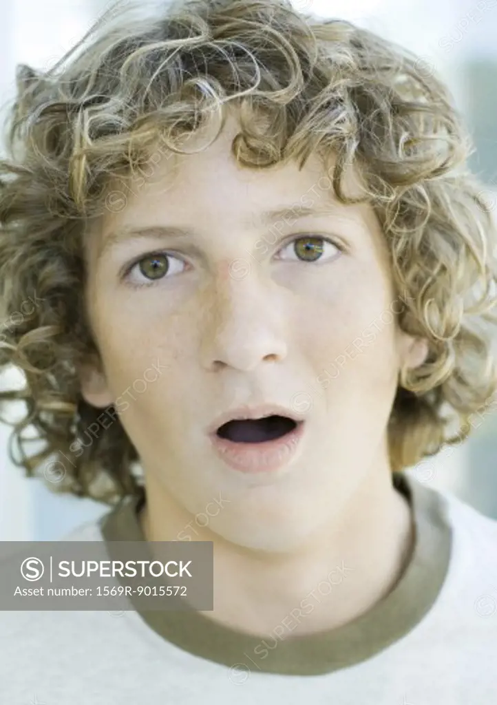Preteen boy with mouth open, portrait