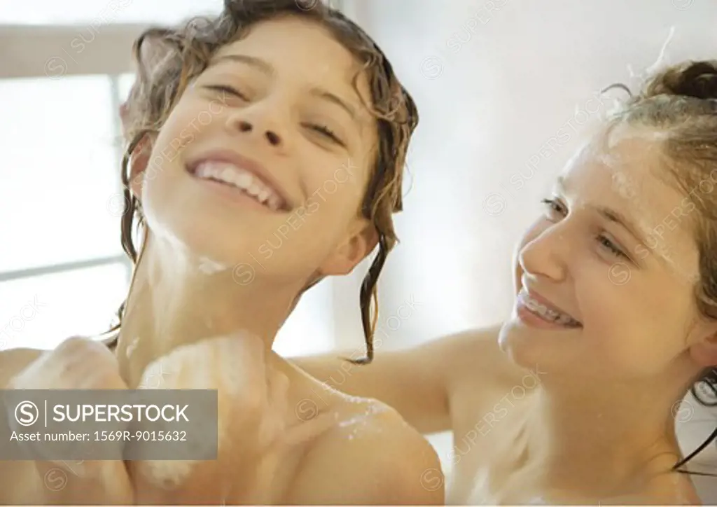 Two preteen girls in shower, laughing