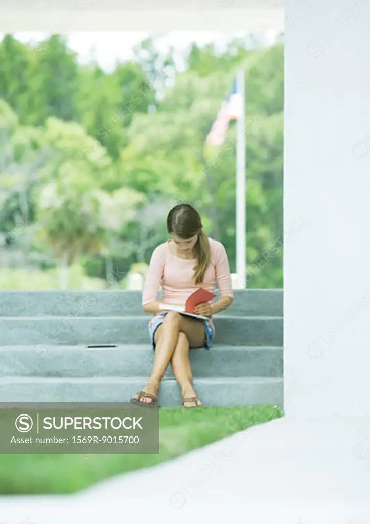 College student studying on steps