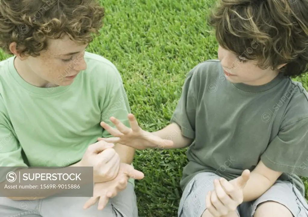 Two boys playing rock paper scissors
