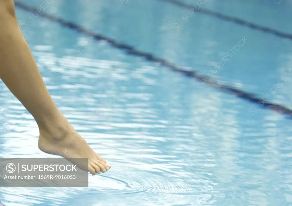 Woman's leg testing water in pool