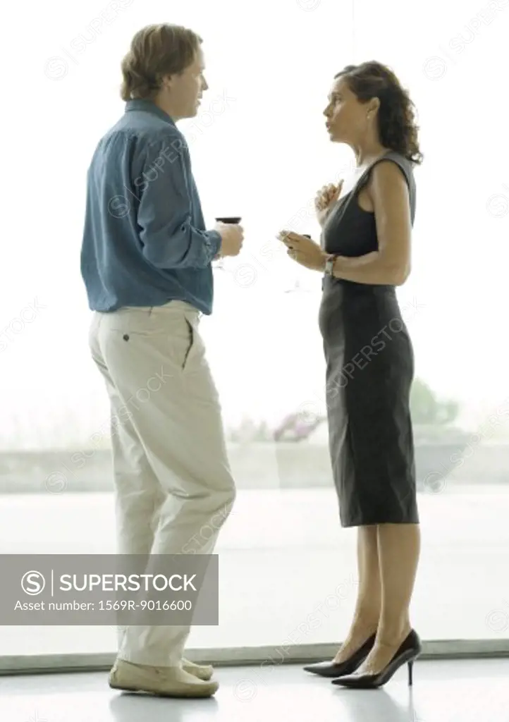 Man and woman talking during cocktail party
