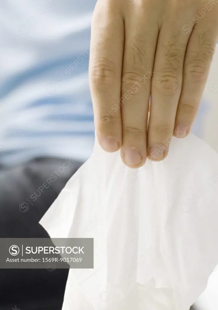 Hand pulling facial tissue