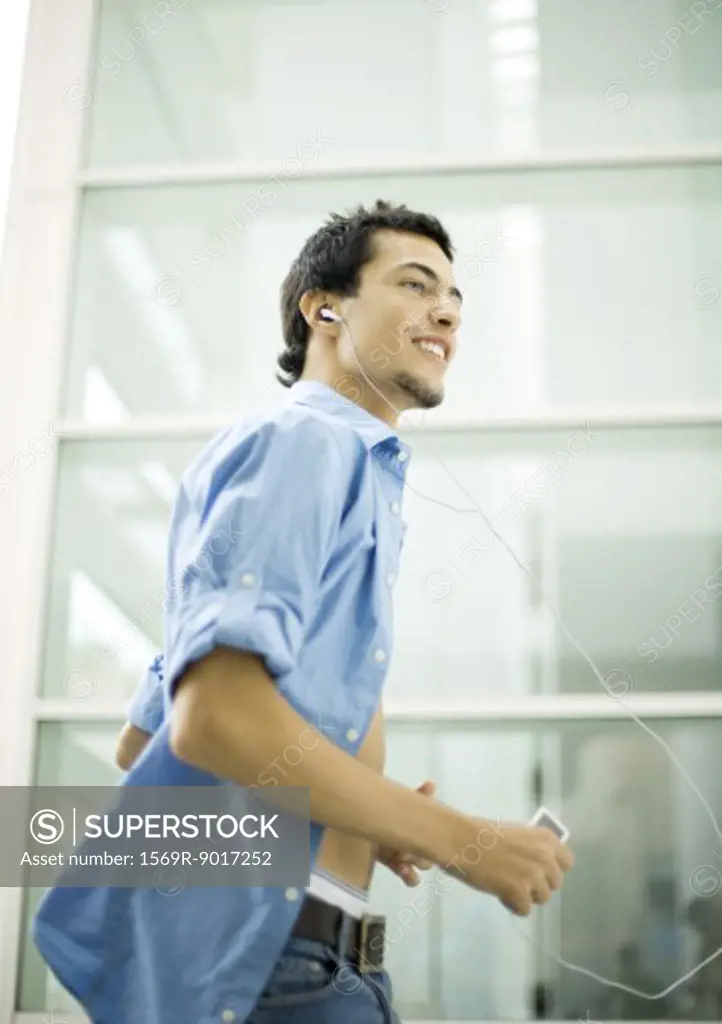 Young man listening to MP3 player