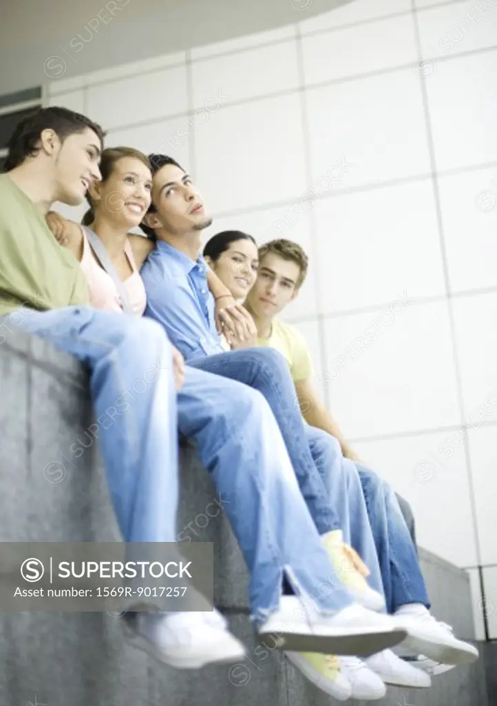 Group of teenage friends sitting side by side