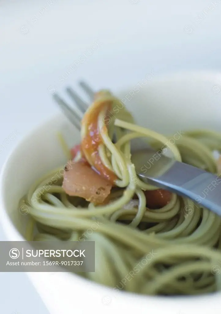 Fork inside bowl of pasta