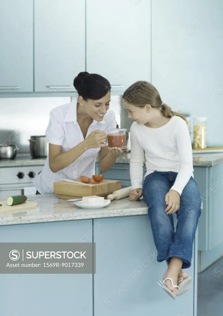 Mother and daughter cooking in kitchen