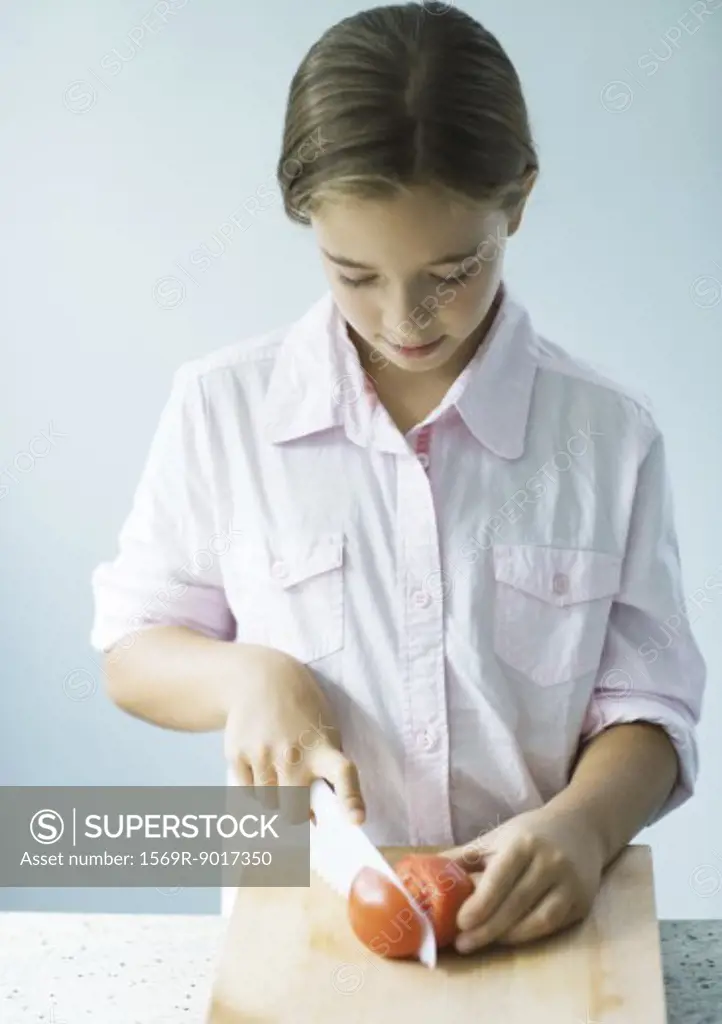 Girl cutting up tomato
