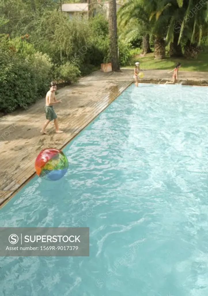 Children playing around swimming pool