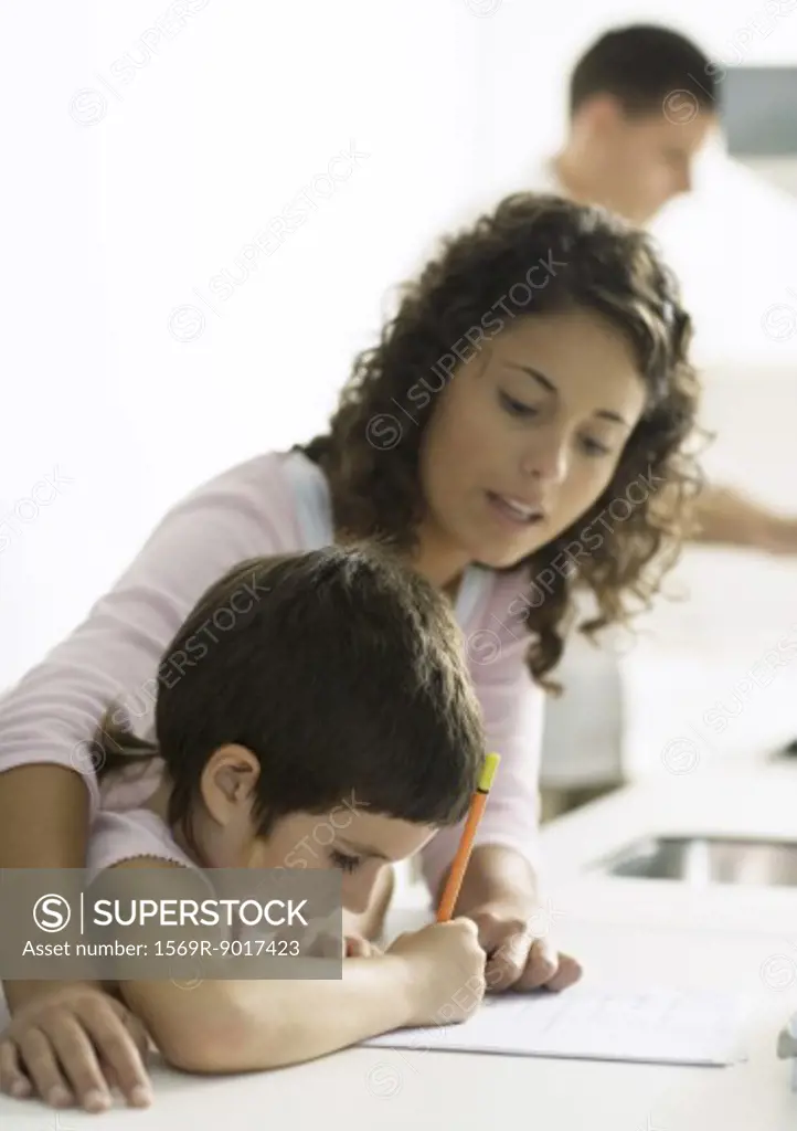 Mother helping child with homework