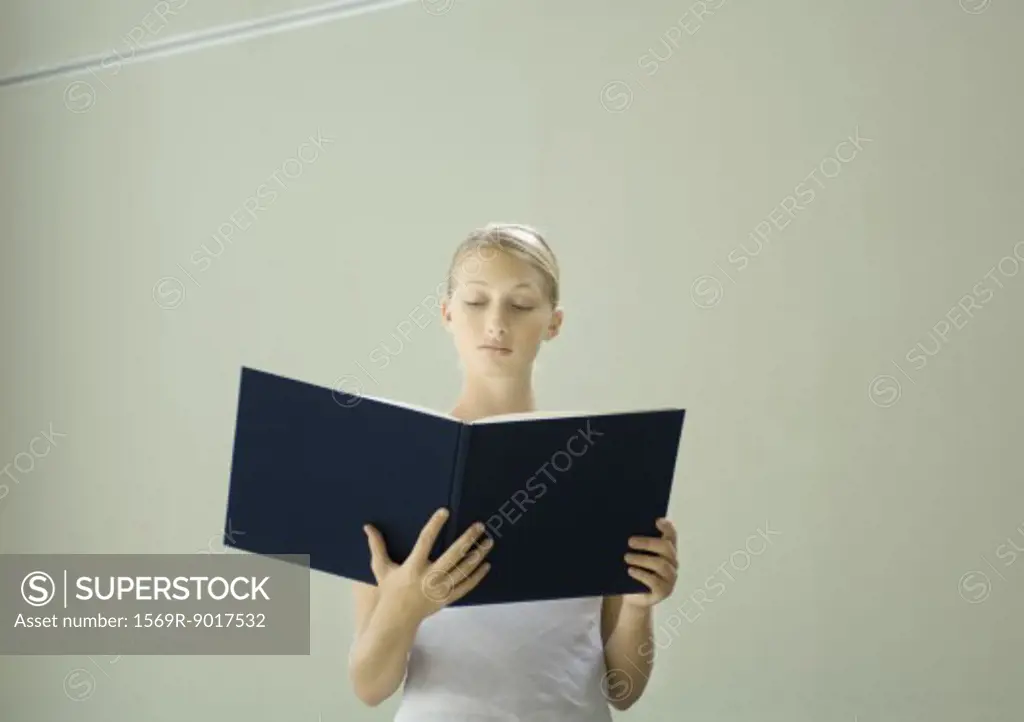 Woman reading large book