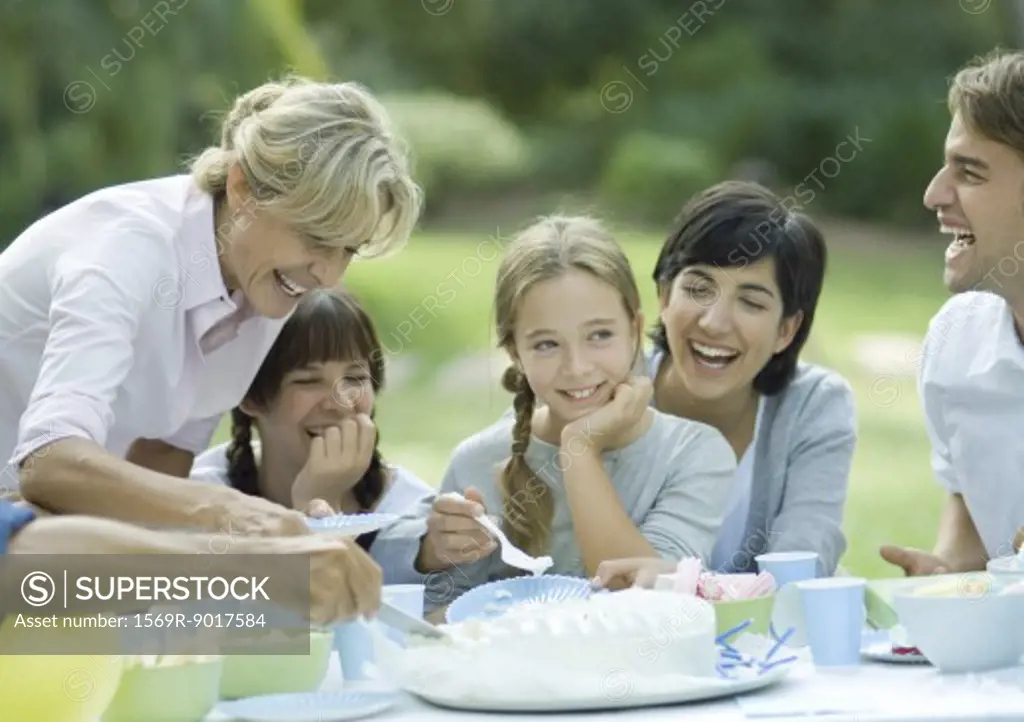 Family having outdoor birthday party