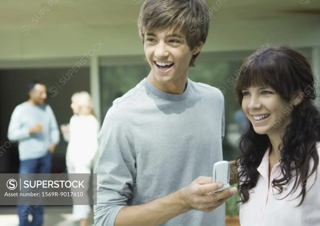 Teenage boy and girl, laughing
