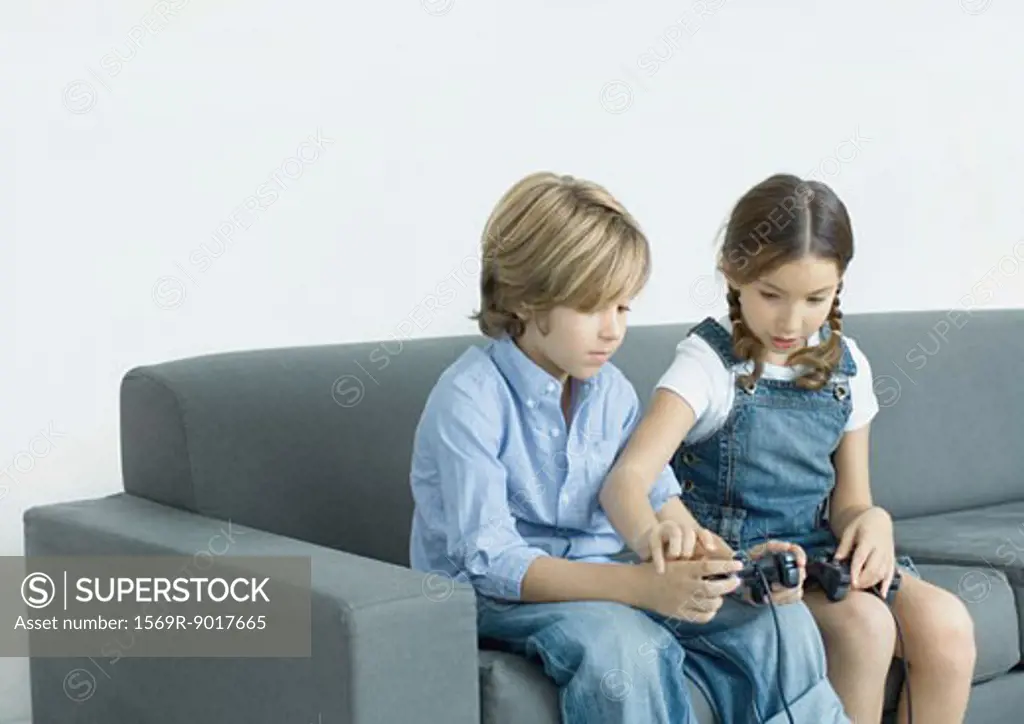 Girl helping boy with joystick