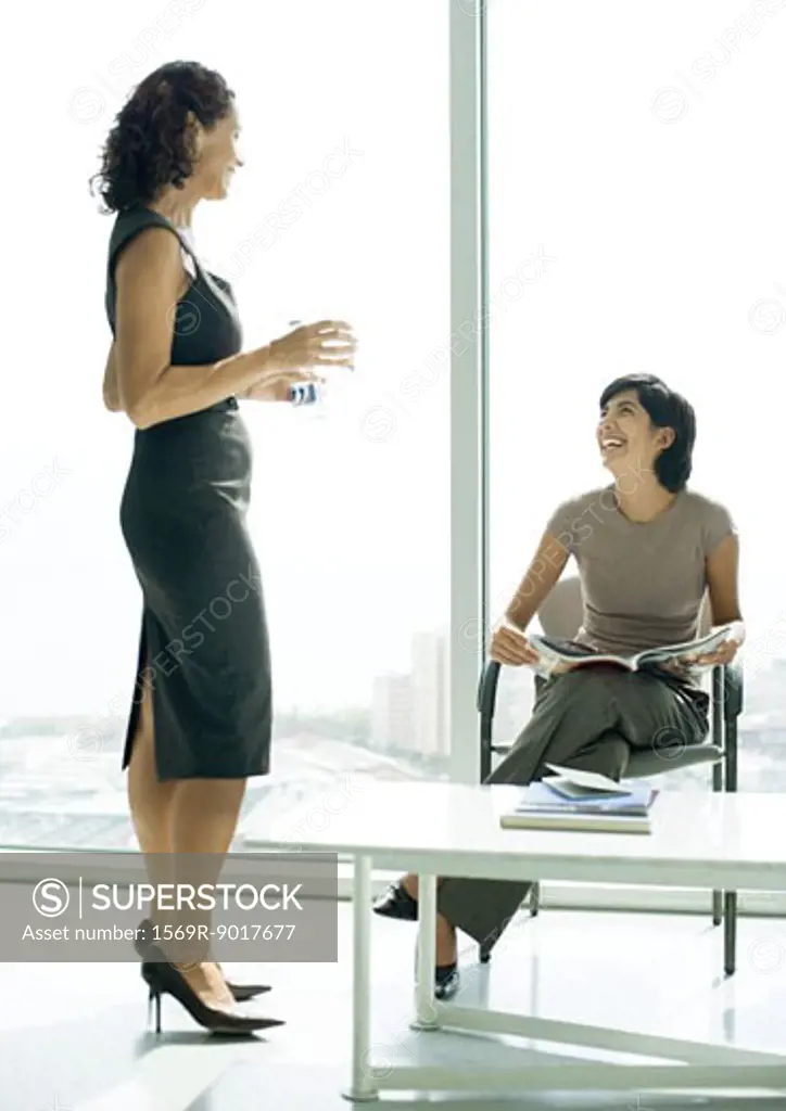 Two women talking in lobby